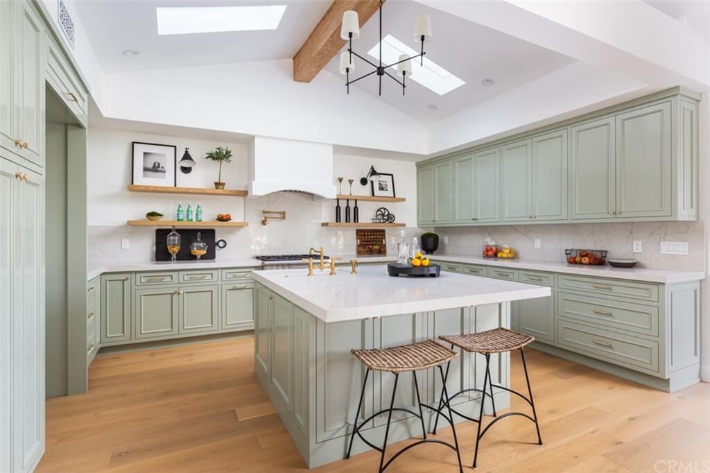 Remodeled kitchen with skylights and pale green cabinets
