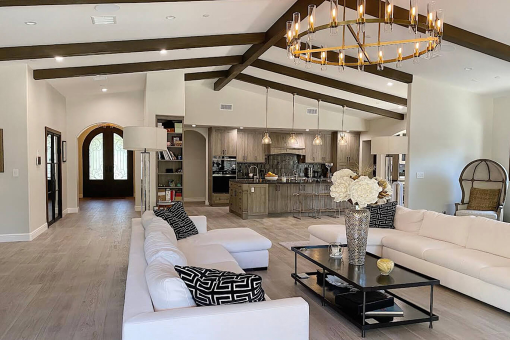 Modern farmhouse style living room with arched doorways and exposed beams