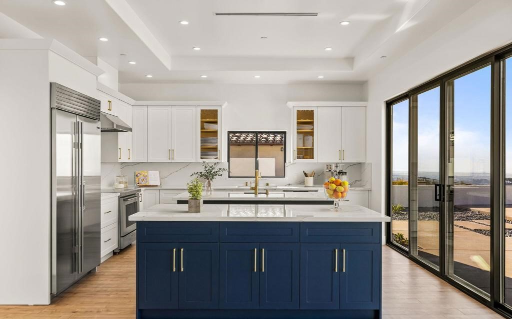 A blue island in a white kitchen