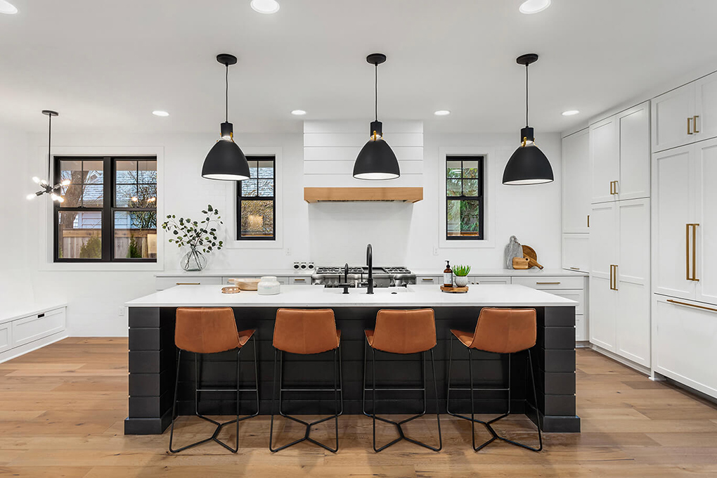 New black and white kitchen with pendant lights over island